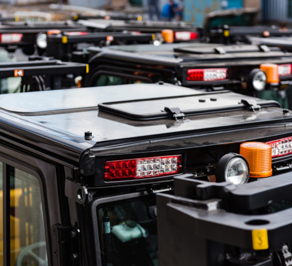 Black roofs of new electric forklift cars. A lot of industrial transport view from up
